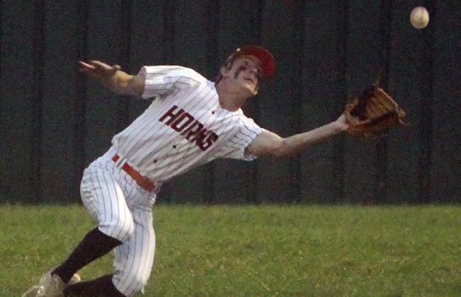 Zane Brenek makes a diving catch in shallow right field against Shiner. Sticker Photo By Darrell Vyvjala