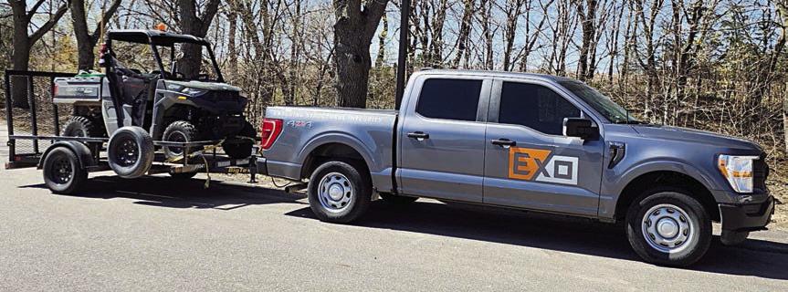 EXO crews are driving gray Ford 150 pickups and utility vehicles with the EXO logo displayed on them while performing metal pole inspections for Fayette Electric Cooperative.
